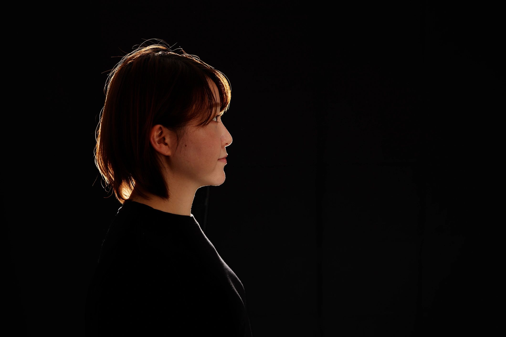 Low-key silhouette portrait on a dark background