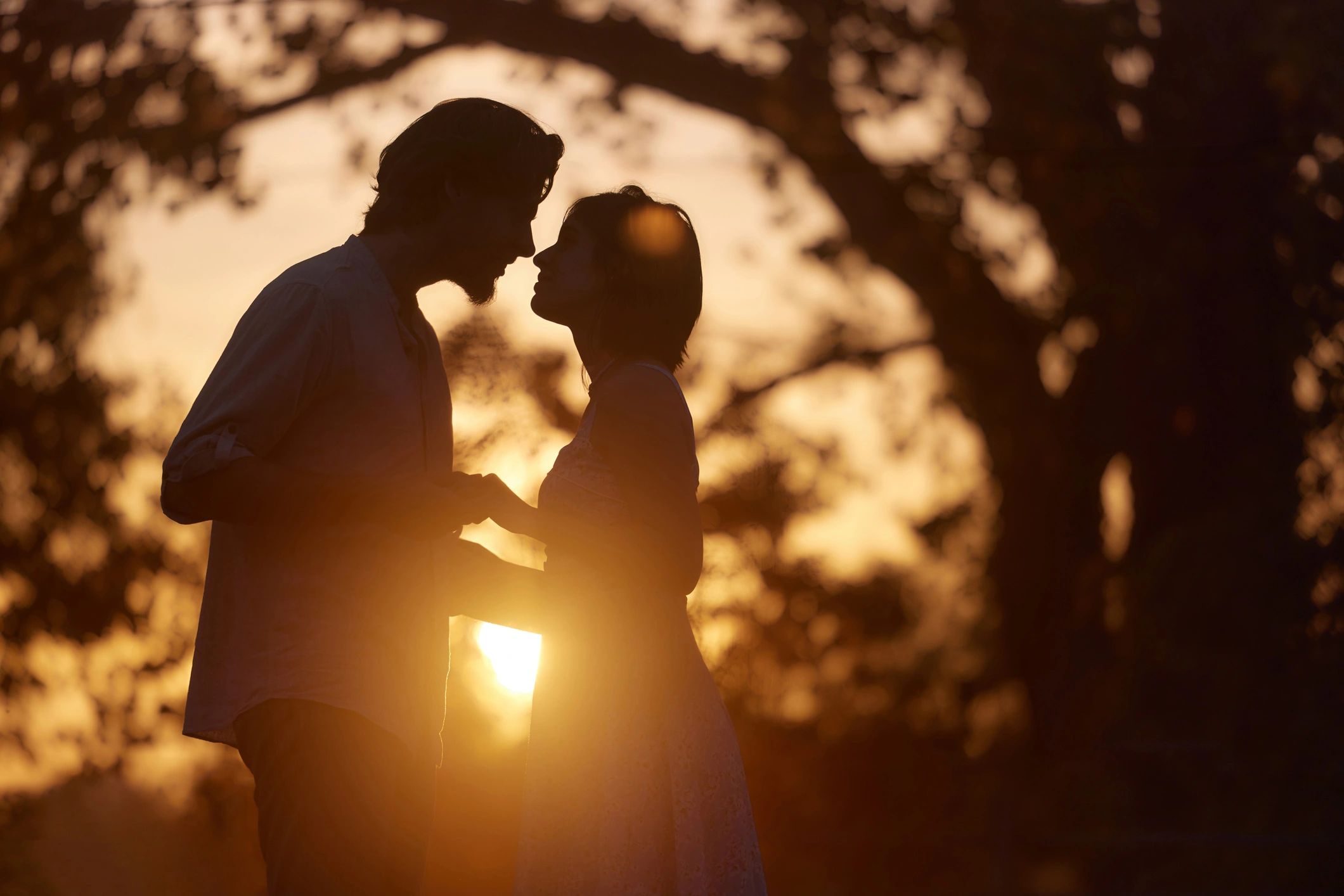Silhouetted couple at sunset, used as a tasteful artistic header image