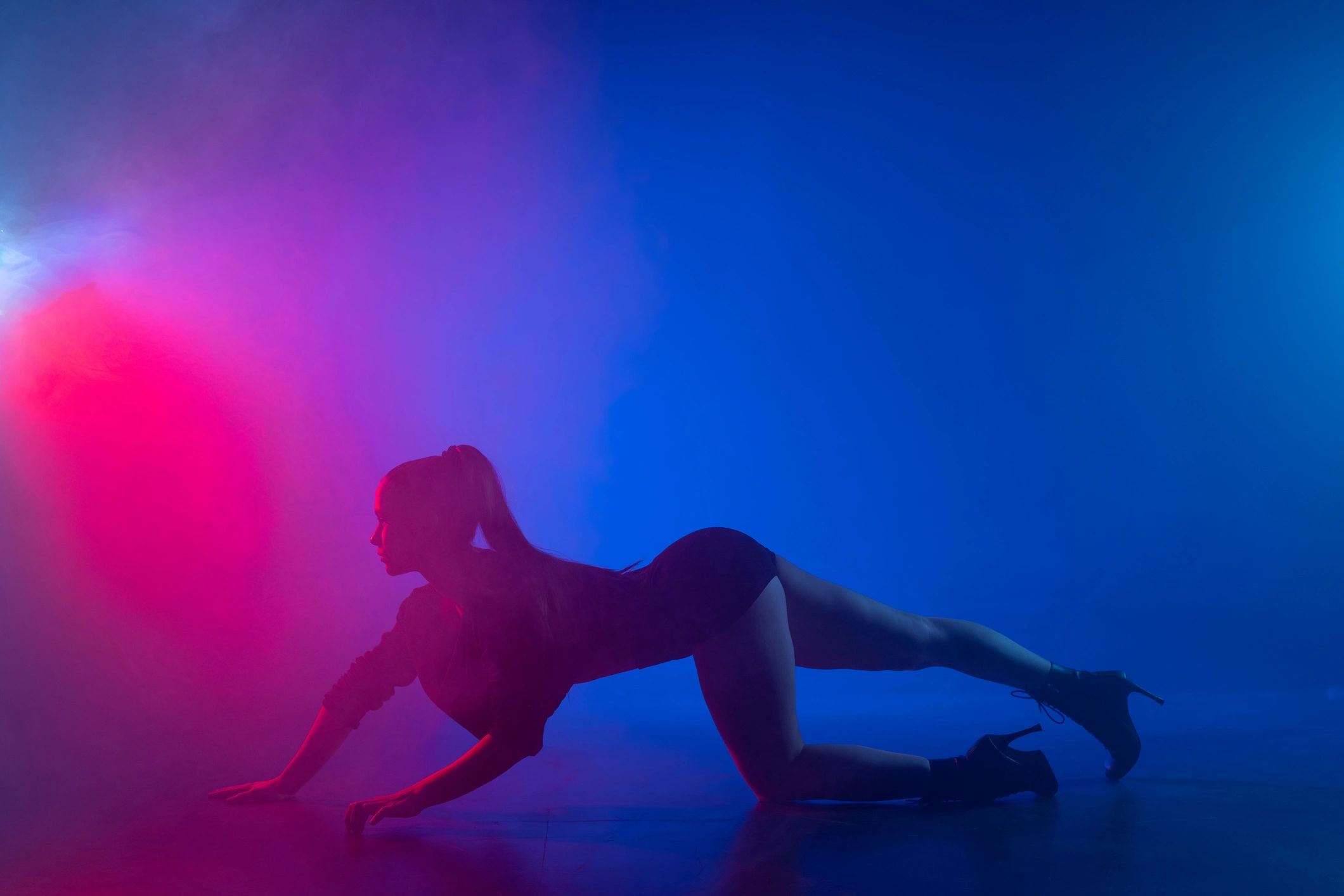 Neon-lit studio silhouette with dramatic color